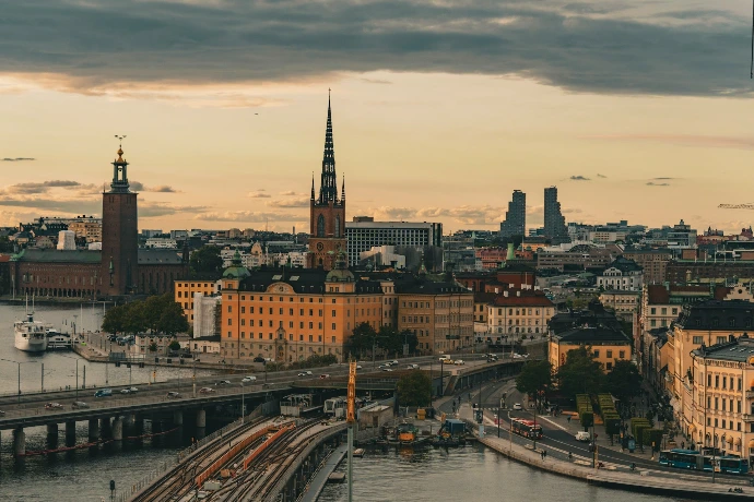 A view of a city with a bridge in the foreground